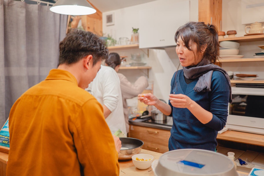 Hosts cooking together in a shared kitchen